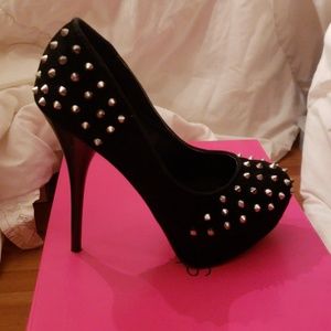 Black suade heels with silver spikes.